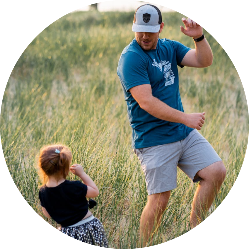 Father and Daughter Playing in a Meadow
